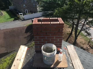 H.E. Chimney technician performing professional inspection